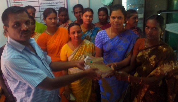 Women's group and facilitator at a community meeting