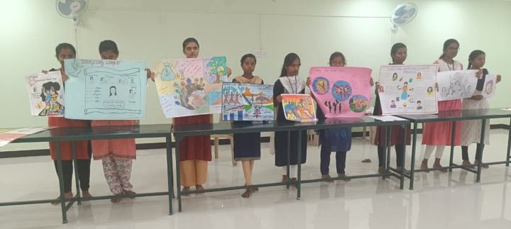 Girls displaying posters in a classroom