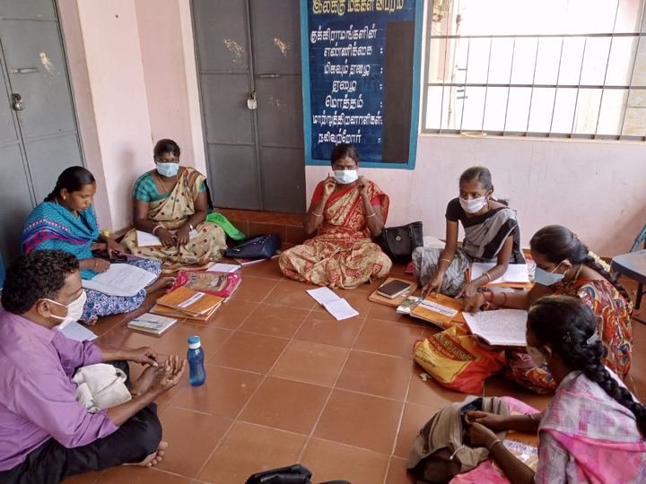 Women seated in a circle during a group meeting